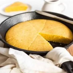 a skillet with a piece of cornbread in it