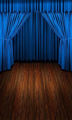 an empty room with blue curtains and wooden floors