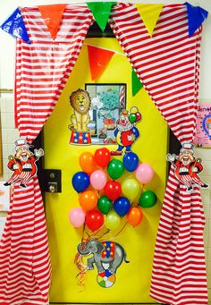 a door decorated with balloons and clowns for a birthday or baby's first birthday