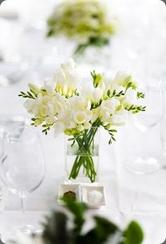 a vase filled with white flowers on top of a table