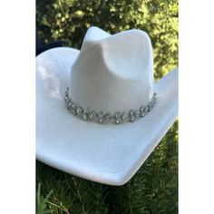 Vegan suede cowboy hat with chain of rhinestones arranged in a floral pattern. Great for concerts, parties, and bridal events. Structured brim. Crown size: 57 cm. Adjustable inner drawstring. 100% polyester Western Hats With Bling For Rodeo, Western Bling Hat For Rodeo, Western Style Bling Hats For Rodeo, Elegant White Hat For Ranch, Elegant White Hats For Ranch, Western Style Silver Party Jewelry, Western Silver Jewelry For Parties, Western Style Silver Jewelry For Party, Western Hat Band With Rhinestones For Country Events