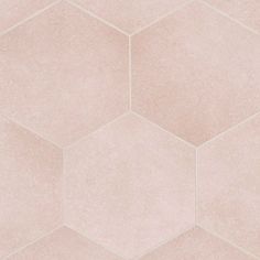 a pink tile wall with hexagonal shapes