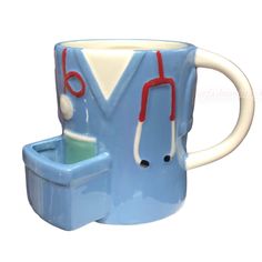 a blue coffee mug with red handles and two stethoscopes on it