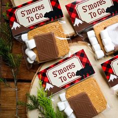 some marshmallows are wrapped in brown and white paper with the words smores to go on them