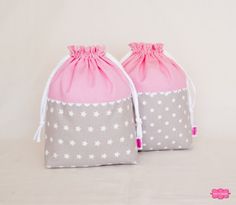 two pink and gray bags with white stars on them