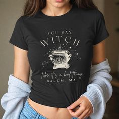 Get ready to be OBSESSED with your new witch baby tee! It's the cutest and most trendy way to emit all those witchy vibes! Great as a gift! * S I Z I N G * ✺ Shirt is a Gildan5000B youth size ✺ Fits like a traditional 90's style baby tee ✺ Check size guide graphic for fit * S H I P P I N G * T I M E S * ✺ Our items are individually made with love for each of our buyers. Because of this, our processing time is 2-5 business days (depending on order volume) plus transit time, but typically much faster. We know our customers want their items as quickly as possible! * K E E P * S H O P P I N G *   ✺ Shop our entire collection here:  https://www.etsy.com/shop/MoonGoddessApparel EXCHANGES: Because all of our items are custom and made to order, our policy is exchange only. In the event that you'd Fitted Gothic T-shirt For Fall, Spooky Fitted Graphic Print Tops, Fitted Spooky Graphic Print Top, Gothic Cotton Tops For Fall, Cotton Gothic Tops For Fall, Fitted Spooky T-shirt For Fall, Spooky Black Cotton Top, Black Cotton Halloween Top, Black Cotton Spooky Top