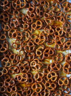 a pizza covered in lots of pretzels sitting on top of a table