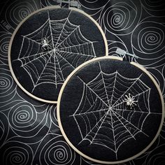 two black and white spider webs are on the hoop