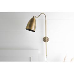 an antique brass swing arm wall light