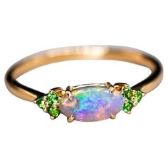 Bright Australian Semi-Black Opal and Tsavorite Garnet Engagement Wedding Ring. Free Domestic USPS First Class Shipping! Free Gift Bag or Box with every order! Opal—the queen of gemstones, is one of the most beautiful gemstones in the world. Every piece of opal is unique in its own ways and patterns. We only use high-quality Natural Opals (NO synthetics or imitations) for our jewelry. ---------------------------------------------------------------------------------------------------- ABOUT THIS Australian Opal Jewelry, Beautiful Gemstones, Tsavorite Garnet, Engagement Wedding Ring, Australian Opal, Natural Opal, Black Opal, Opal Jewelry, Jewelry Rings Engagement