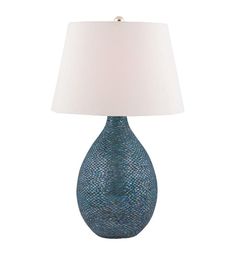 a blue table lamp with a white shade on the base and a light in front of it