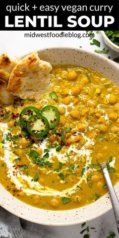 a white bowl filled with lentula soup and topped with bread