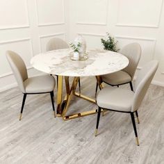 a marble table with four chairs around it