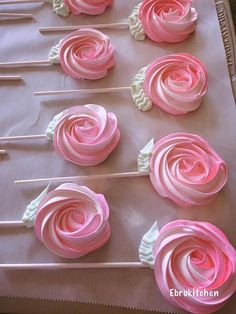 pink and white cupcakes are on a tray