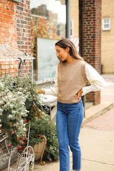 The Tan Sweater Vest with Cream Sleeves offers a stylish and comfortable layering option. Featuring a relaxed fit and high-stretch fabric, this vest ensures a cozy and flexible wear. The crew neck adds a classic touch, while the attached cream sleeves create a unique and contemporary look. Unlined for a lightweight feel, this vest blends seamlessly into your wardrobe, providing both warmth and a sophisticated edgeModel & Fit Model: Elena (5' 7" and Size 6 or S) is wearing a size smallChansey (5' Tan Sweater Vest, Tan Sweater, Beige Top, Sweatshirt Set, Swimwear Sale, Pullover Jacket, Top Sales, Sweater Vest, Dress Pants