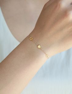 "Dainty bracelet with tiny sideways letter(s) of your choice. A modern way to keep your cherished memories close to you with a name, a word, or multiple initials with a heart or ampersand. D E T A I L S * Each initial is approximately 4.5 x 7 mm * Bracelet length is 6.5\" to 7.5\" adjustable * For a different length than the above, write it in the note box at check out * Chain is 14k gold fill // sterling silver * Charms are 14k gold plate // silver plate F O L L O W Instagram: @Minthologie Face Everyday Name Bracelet For Valentine's Day, Initials Charm Bracelet Gift, Adjustable Everyday Gold Bracelet For Mother's Day, Dainty Adjustable Bracelet With Initials, Jewelry Name, Sterling Silver Charms, Letter Bracelet, Bracelet Dainty, Dainty Bracelet