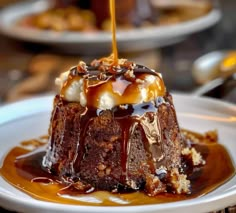 a piece of chocolate cake with caramel sauce drizzled over it on a white plate