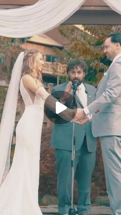 a bride and groom holding hands during their wedding ceremony