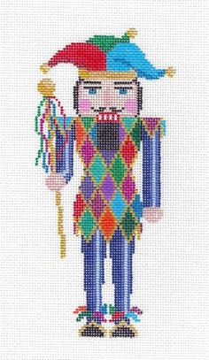 a cross - stitch pattern of a clown holding a wand and wearing a hat with beads