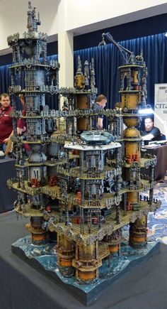 a large model of a city made out of metal pipes and other mechanical components on a table