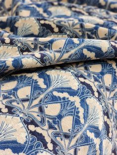 the blue and white fabric has an intricate design on it's side, as well as