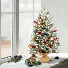 a small christmas tree with lights and decorations