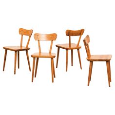 three wooden chairs sitting next to each other