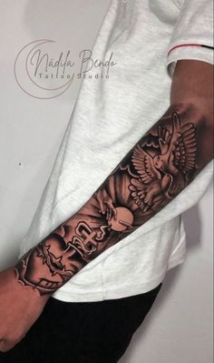 a man's arm with an eagle and skull tattoo on the left forearm,