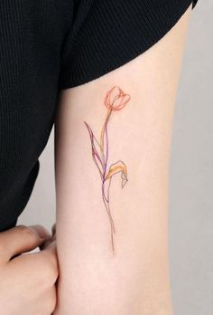 a woman's arm with a flower tattoo on the left side of her body