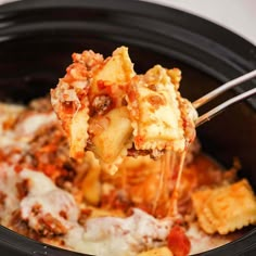 a close up of a spoonful of pasta casserole with meat and cheese