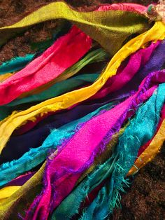 multicolored scarves laid out on the ground