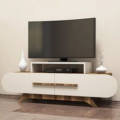 a flat screen tv sitting on top of a white entertainment center