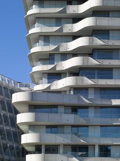 a tall building with many balconies on it's sides and some windows