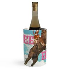 a bottle of wine in a cup with an image of a woman riding a horse