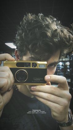 a young man taking a photo with his camera