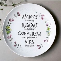 a white plate with flowers on it that says, amigos restas conversas via meds felize