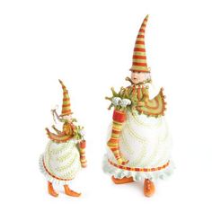 two small figurines with colorful hats and dresses