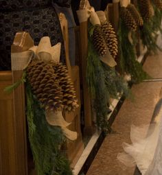 pine cones are tied to the pews at a wedding