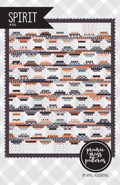 an orange and white quilt with the words spirit written in black on it, next to a