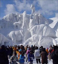 several people standing in front of an ice sculpture