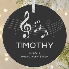 a black ornament with white music notes and the words timothy on it