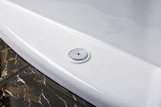 a close up of a bathroom sink with marble flooring