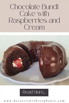 a chocolate bundt cake with raspberries and cream is on a white plate