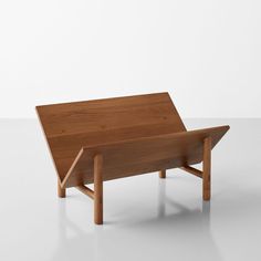 a wooden table sitting on top of a white floor