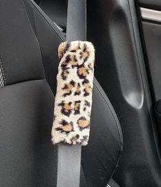 an animal print seat belt cover in a car