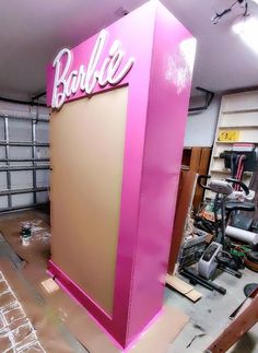 there is a pink sign that says barbie in the middle of it's frame