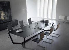 an empty conference table with chairs around it