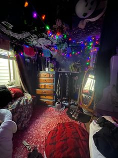 the bedroom is decorated with christmas lights and decorations on the ceiling, along with many other items