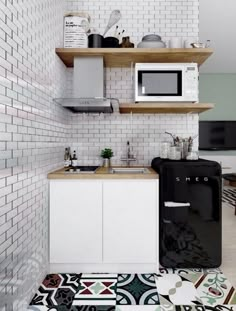 a small kitchen with white brick walls and floor tiles on the floor, along with a black refrigerator freezer