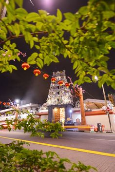 a street scene with focus on the building and trees in the foreground at night